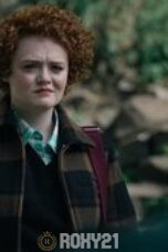 a woman with curly red hair